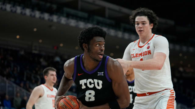 Dec 9, 2023; Toronto, Ontario, CAN; TCU Horned Frogs center Ernest Udeh Jr. (8) grabs a rebound against Clemson Tigers forward Ian Schieffelin (4) during the second half at Coca-Cola Coliseum. Mandatory Credit: John E. Sokolowski-USA TODAY Sports  